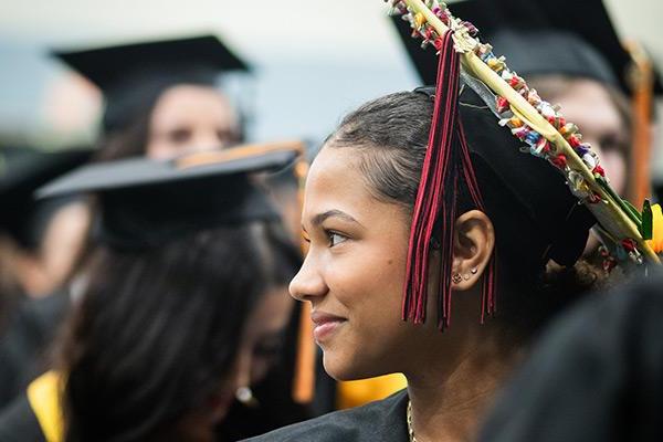 Graduation student smiling and looking off to the side